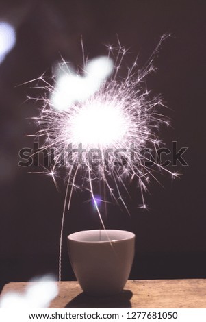 Blur sparkler in cup for celebration Christmas and happy new year party on park background.