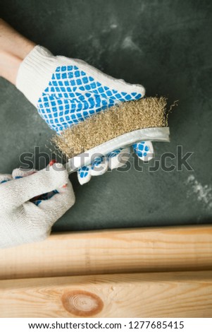 Repair modern tools: man hands in gloves on dark stone background, top view, copy space