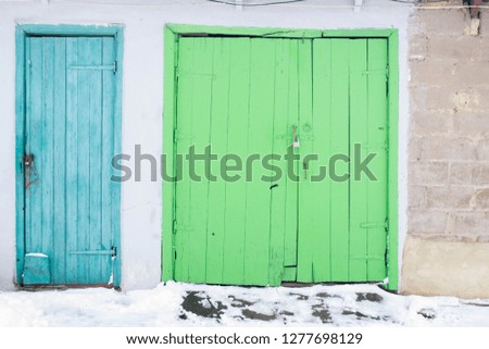 Blue door with a green gate in the wall