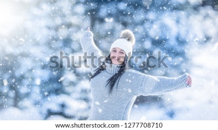 Winter portrait of happy attractive young woman in warm clothing
