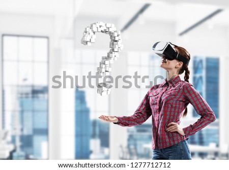 Young woman in virtual reality helmet and question white symbol. Mixed media