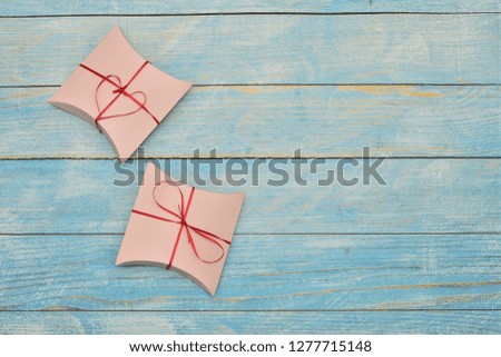 Beautiful valentines day paper hearts on blue wooden background. romantic background greeting card, box, strips and hearts. space for text