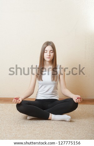 Young Blond Woman do yoga indoors. Fitness concept for health club