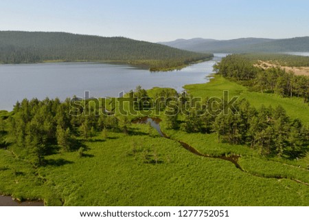 Aerial view of the green forest in the 
North of  Khabarovsk territory, far East, Russia.