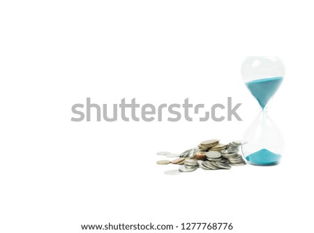 Pile of coins with an hourglass isolated on white background.