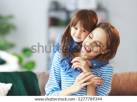 happy loving family a mother and child daughter hugging at home
