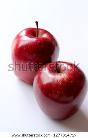 It is a close-up picture of a juicy red apple on a white background