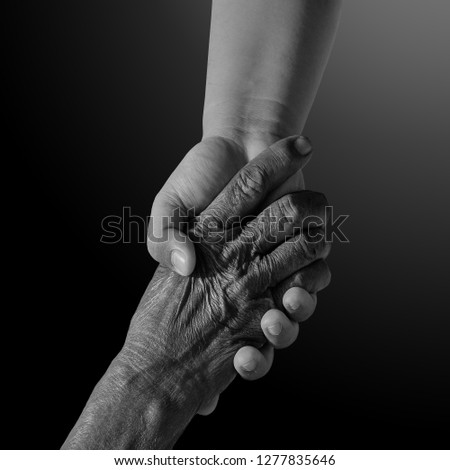 Old and young person holding hands. Elderly care and respect, .black and white photography. space for text.family, generation, support and people concept -senior man and child holding hand Royalty-Free Stock Photo #1277835646