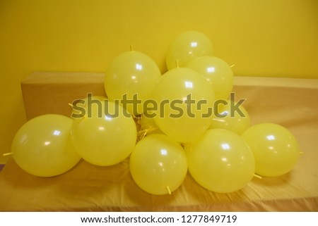 yellow inflatable balls on a yellow background