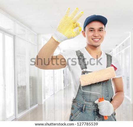 Painter showing ok sign on building site