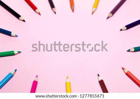 Seamless colored rainbow pencils lined around the contour, on pink background isolated. Concept of free space, copyspace, cover of notebook, album for drawing in school for professional use
