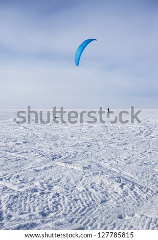 Winter kite skiing on the frozen river