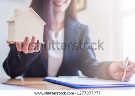 blur photo,Real estate agents have submitted home forms and samples to customers after successfully offering a home sale in the real estate agent's office. The concept of buying insurance and housing