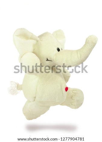 Valentine's holiday, red heart, white plush elephant, jumping. Isolated object on a white background, closeup.