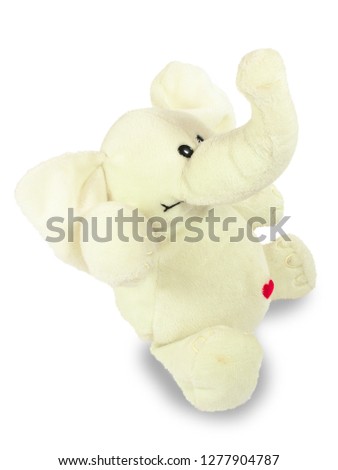 Valentine's holiday, red heart, white plush elephant, sits. Isolated object on a white background, closeup.