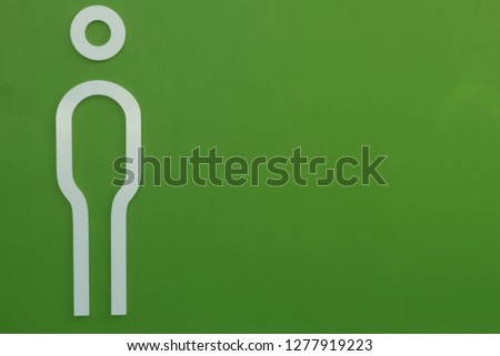 White Man toilet sign on green wall space for design background