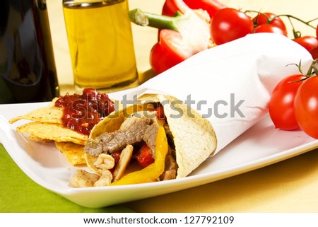 Mexican tortillas and its ingredients on the wooden table