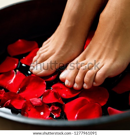 Foot washing in the spa salon. Legs massage concept. Feet spa.