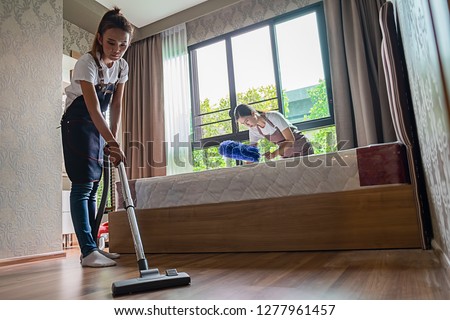 Professional cleaning service team working with cleaning equipment in room. Cleaning Service Concept. Royalty-Free Stock Photo #1277961457