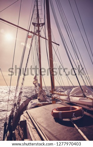 Old schooner at sunset, travel and adventure concept, color toned picture.