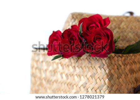 A picture of a red roses in rattan basket on white background. This picture is suitable for such sweet occasions as Valentine's day, romantic, dating and etc. It can also be used as a text picture.  