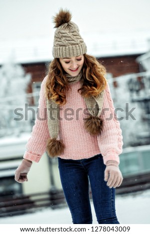 Attractive young woman ice skating during winter