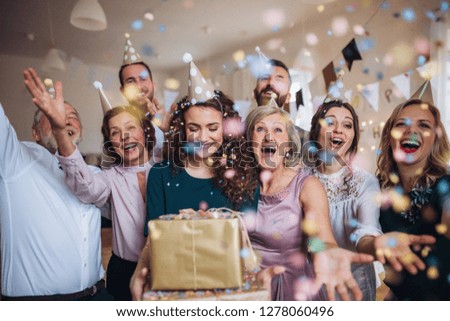 A portrait of multigeneration family with presents on a indoor birthday party. Royalty-Free Stock Photo #1278060496