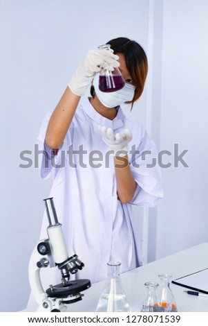 Female scientist portrait doing research with microscope, hand holding flask on white Background, Laboratory science experiment study education, healthcare or cosmetic lab concept with copy space.
