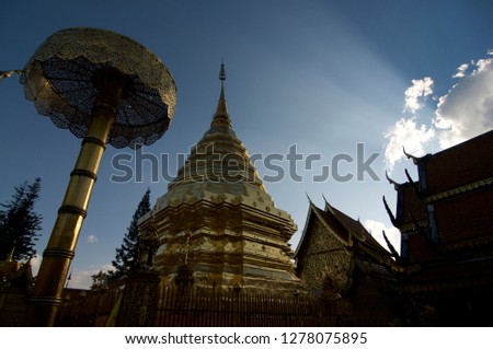 Picture of the Wat Phra Doi Suthep temple with some beautiful sunbeams in the background blue sky, Chiang Mai, Thailand