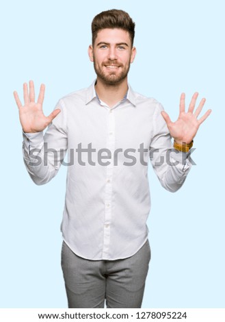 Young handsome business man showing and pointing up with fingers number ten while smiling confident and happy.