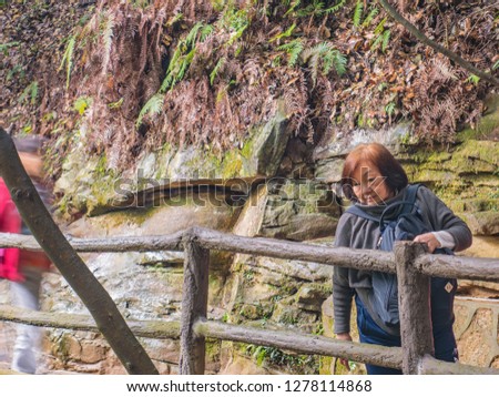 Portrait photo of Senior asian women with Beautiful mountain of Yuanjiajie or Avartar mountain at Zhangjiajie National Forest Park in Wulingyuan District Zhangjiajie City China