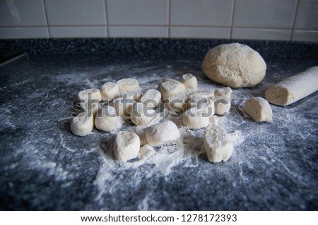 Making handmade lazy dumplings from eggs, flour and cottage cheese
 on dark background 