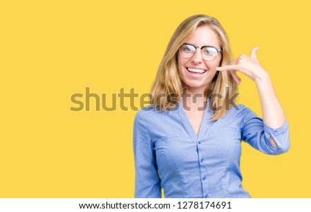 Beautiful young business woman over isolated background smiling doing phone gesture with hand and fingers like talking on the telephone. Communicating concepts.