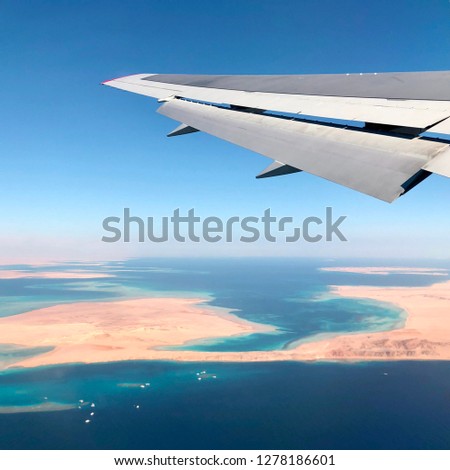 airplane wing over Sharm el-Sheikh Egypt tourism resort city dream
