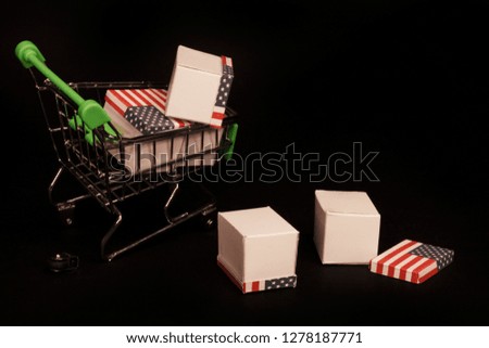 broken shopping cart and spilled boxes on black background
