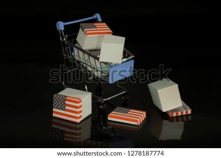 broken shopping cart and spilled boxes on black background
