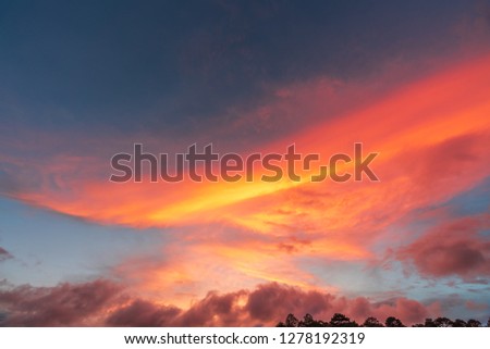 Red Clouds At Sunset With Blue Sky Reflecting