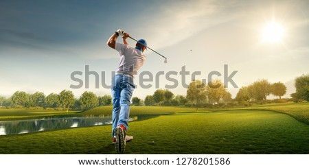 Male golf player on professional golf course. Golfer with golf club taking a shot Royalty-Free Stock Photo #1278201586