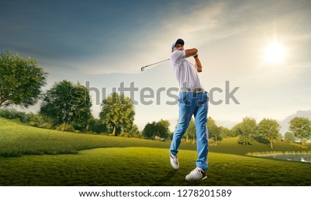 Male golf player on professional golf course. Golfer with golf club taking a shot Royalty-Free Stock Photo #1278201589