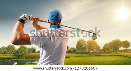 Male golf player on professional golf course. Golfer with golf club taking a shot Royalty-Free Stock Photo #1278201607