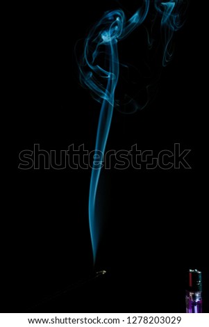 white smoke on black background. smoke waves from gas lighter