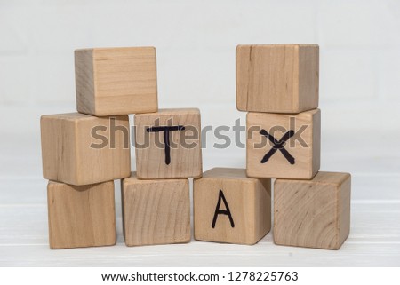 Wooden cubes with text 'TAX' on it