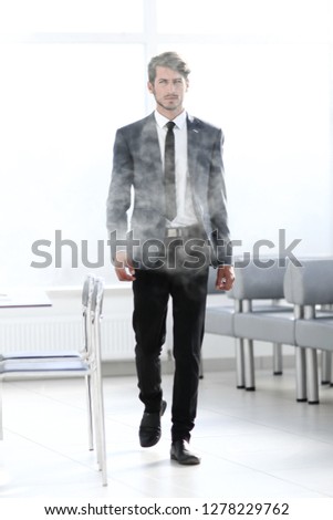 full-length businessman in a smoky office