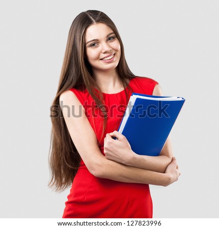 Beautiful business woman holding folder on light grey background