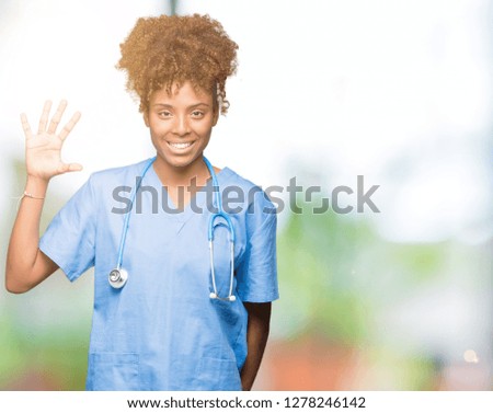 Young african american doctor woman over isolated background showing and pointing up with fingers number five while smiling confident and happy.
