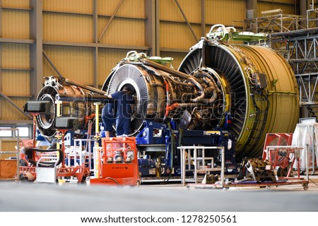 Jet engine remove from aircraft (airplane) for maintenance at aircraft hangar.Jet engine maintenance and change part by aircraft technician . Royalty-Free Stock Photo #1278250561