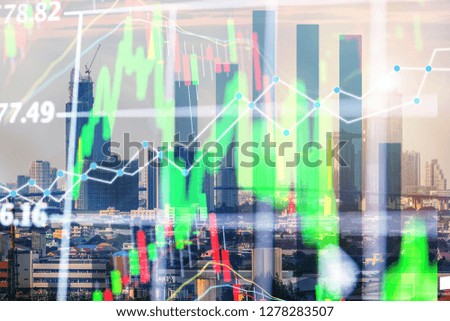 Double exposure business trading graph and network connection on city background.