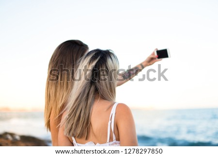 Two friends at outdoors making a selfie