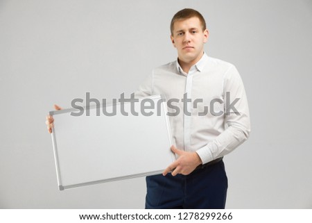 Entrepreneur with a magnetic Board in his hands on white background
