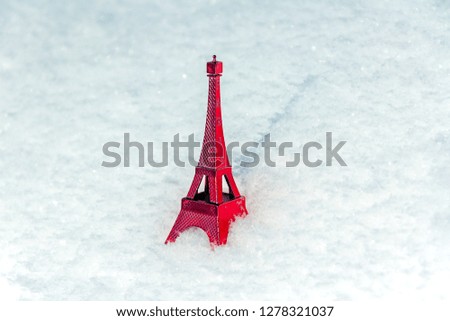 The red Eiffel Tower on snow